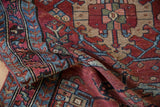 Textured cherry red, powder blue geometric and serrated leaf main border of a vintage Mehreban rug.