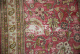 Vintage Distressed Doroksh rug: worn dusty magenta field with sprawling vines, paisley border.