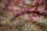 Textured distressed magenta field with vine motifs and a pale blue paisley border.