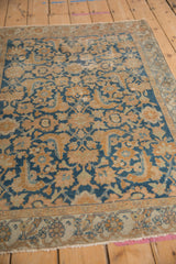 Vintage Malayer rug's distressed sky blue and terracotta Herati pattern texture.
