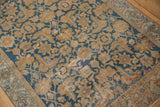 Distressed Malayer rug showing worn sky blue and terracotta Herati motifs, foundation visible.