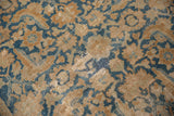Vintage Malayer rug detail, aged Herati pattern in sky blue and terracotta, with visible knot heads.