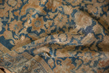 Worn texture of distressed Malayer rug with sky blue, terracotta Herati pattern.