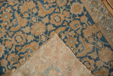 Distressed blue and terracotta Herati pattern on vintage Malayer rug with exposed hand-knotted foundation.
