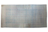 Vintage distressed Khotan carpet with an allover pomegranate pattern in faded powder blue and pink.