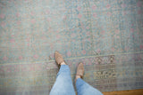 Soft, distressed pile of a vintage Khotan rug in powder blue, pink, and saffron yellow.