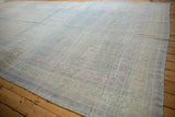 Long view of an oversize distressed Khotan carpet with a soothing, faded pastel color palette.