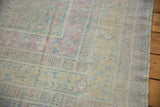 Worn pile showing knot heads and geometric borders in soft pink and powder blue.