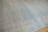 Surface view of a distressed Khotan rug showing worn texture in powder blue, pink, and ivory.