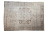 Vintage distressed Oushak carpet with a faded concentric medallion in soft platinum and pale coffee brown.