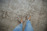 A distressed vintage Oushak carpet showing its characterful low-pile texture and wear from above.