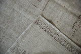 The hand-knotted foundation and secured side cord of a vintage distressed Oushak carpet.