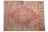 Distressed Joshegan carpet, central diamond medallion, dusty pink and blue botanical patterns, 8'10