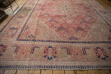 Vintage Distressed Joshegan carpet with navy and red reciprocating pawn borders.
