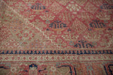 Vintage Distressed Joshegan carpet with red field, navy pawn border, and visible foundation wear.