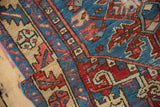 A close-up view of the hand-knotted pile on a vintage Karaja rug's sand and sky blue border.