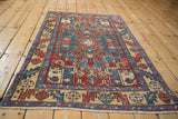 Angled view of the vintage Karaja rug showing its full geometric design and low-pile texture.