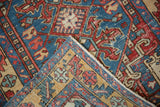 Hand-knotted construction and pile wear detailed on the corner of a vintage Persian rug.