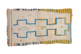 Vintage Moroccan rug featuring geometric ivory, sky blue, and saffron yellow medallions.