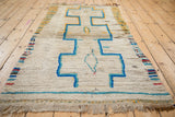 Thick, hand-knotted ivory pile, colorful side selvages, and fringe on vintage Moroccan rug.