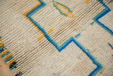 Hand-knotted vintage Moroccan rug pile, geometric dusty turquoise and saffron yellow lines.