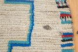 Vintage Moroccan rug detail: ivory pile and matted wax-like stain.