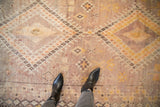 Distressed Moroccan runner with textured geometric stars and checkered floral in muted tones.