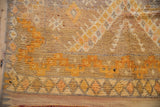 Distressed vintage Moroccan rug pile, showing saffron yellow and aged ivory.