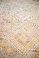 Distressed Moroccan runner pile with geometric patterns in soft aubergine and saffron.