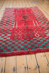 Angled view of a vintage Moroccan rug highlighting its plush texture and geometric design.