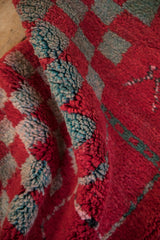 Close-up view of the thick, blooming wool pile and selvage of the Moroccan rug.