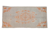 Vintage Moroccan runner with an unusual coral medallion and floral spandrels on an abrashed blue field.
