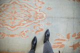 The textured pile and knot heads of a Moroccan runner with coral floral designs on an abrashed blue field.