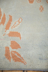 Soft hand-knotted wool pile texture of a vintage Moroccan rug in terracotta and powder blue.