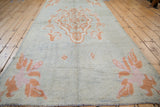 Long view of a vintage Moroccan runner, highlighting its nubby, textured pile and floral designs.