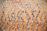 Distressed vintage Moroccan carpet pile with shaggy faded gold, ivory, and brown texture.