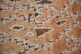 Distressed wool and upcycled cotton pile in faded gold, ivory, and rich brown tones.
