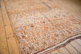Textural, distressed pile in faded gold, ivory, and chocolate brown with original selvage.