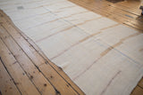 The textured flatweave and a visible patch on a vintage distressed hemp kilim runner.