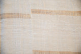 The rustic, hand-woven texture and blanket-stitched seam of a vintage hemp kilim runner.