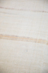 Close-up of the hand-woven hemp texture with a time-softened color band.