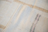 Reverse view of the hand-woven hemp foundation and assembly seam on a vintage kilim runner.