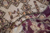 Deep, shaggy pile of a vintage Moroccan carpet with violet, ivory, and apricot tones.