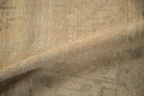 Hand-knotted wool foundation and weave visible on the back of the distressed Mehrivan carpet.