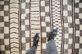 Vintage Moroccan carpet pile with ivory, beige, black horizontal and checkered patterns.