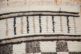 Vintage Moroccan carpet fringe, high-low pile, ivory and dark horizontal lines.