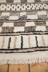 Ivory, black, beige geometric patterns on a vintage Moroccan abstract rug with varied pile.