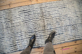 Textured pile of vintage Moroccan runner showcasing ivory, silver, and charcoal abrash waves.