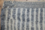 Vintage Moroccan rug runner with shaggy ivory and charcoal pile texture, woven end.