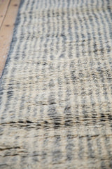 Moroccan rug runner with textural ivory and charcoal striped pile.